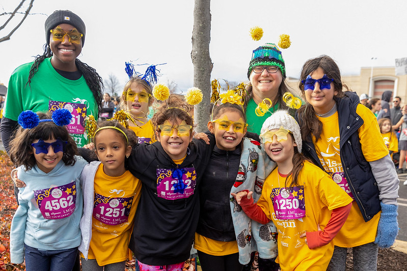 Group of Girls on the Run participants smiling at the 5K.