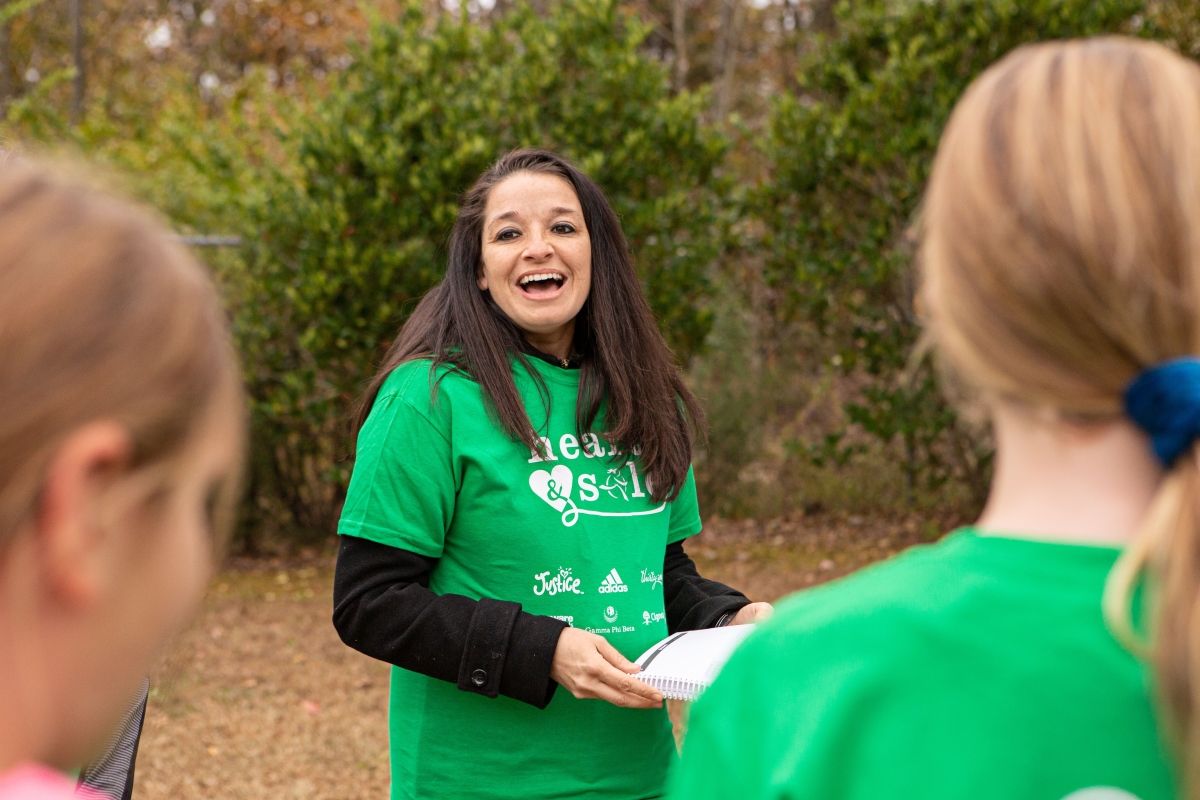 Girls on the Run coach smiling at her team.