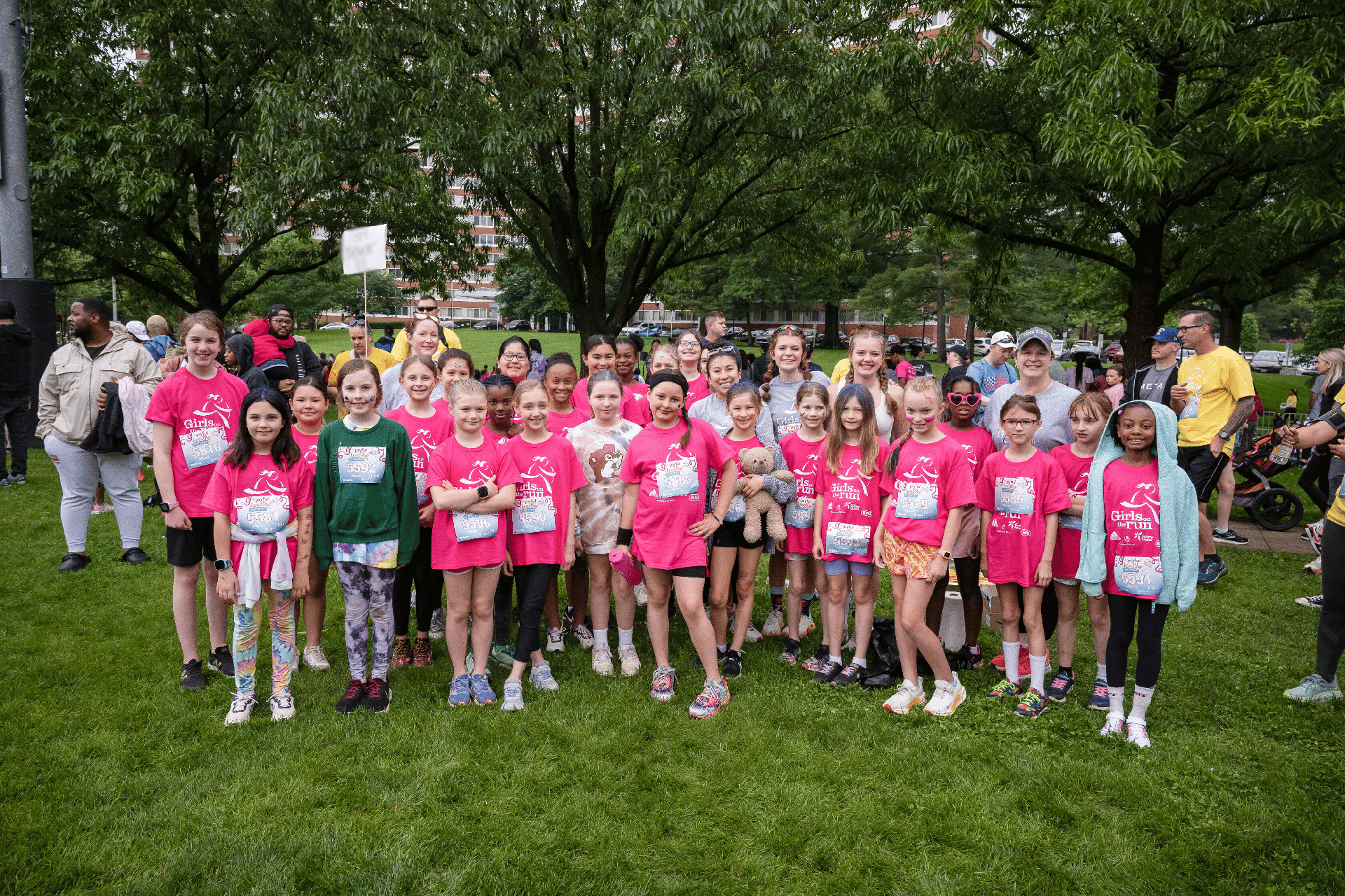 Girls on the Run team posing for a photo at the 5K wearing matching pink shirts.