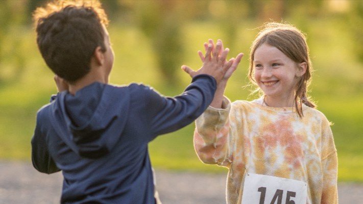 Two kids high-fiving.