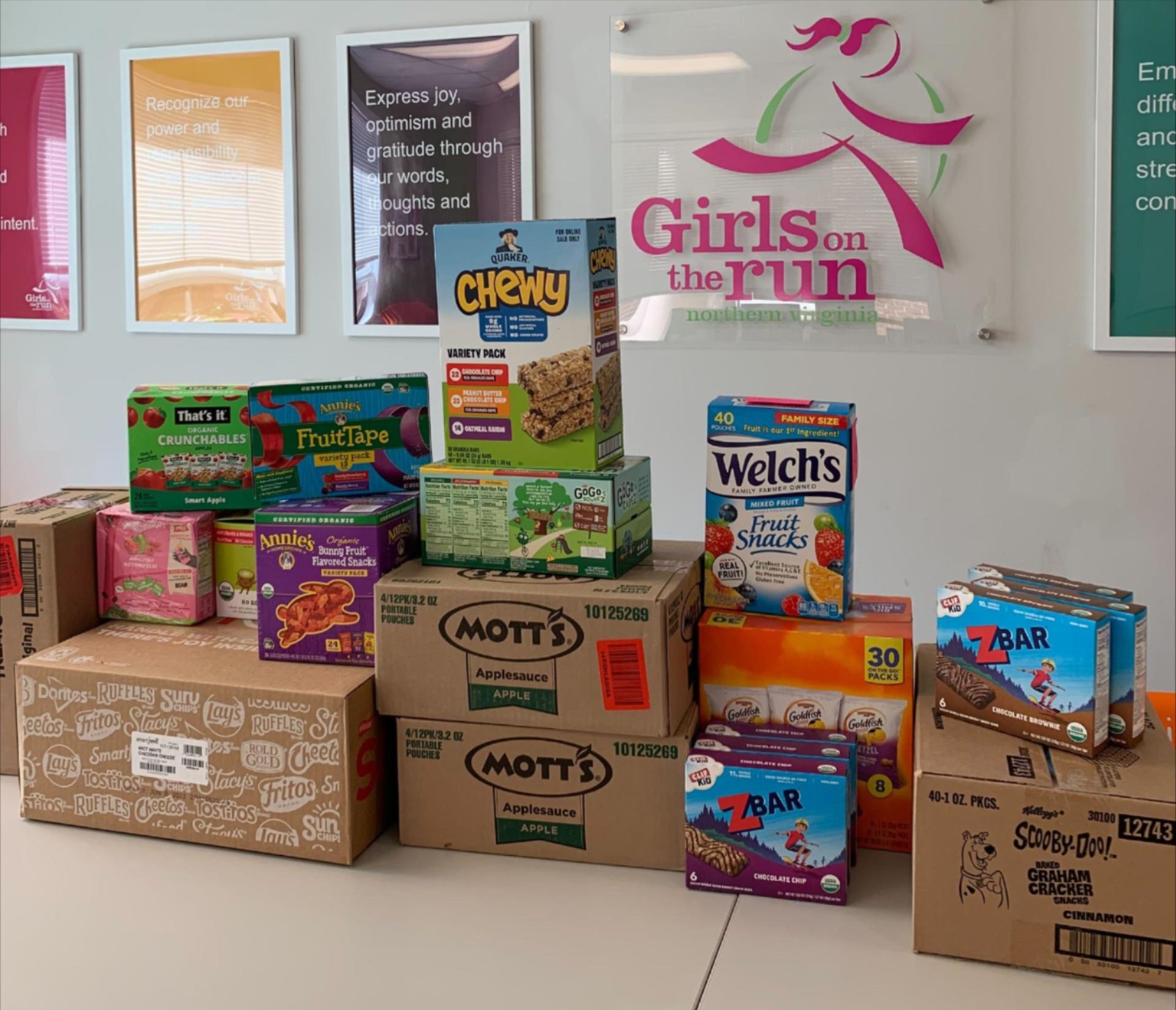 Boxes of snacks piled in the Girls on the Run NOVA office.