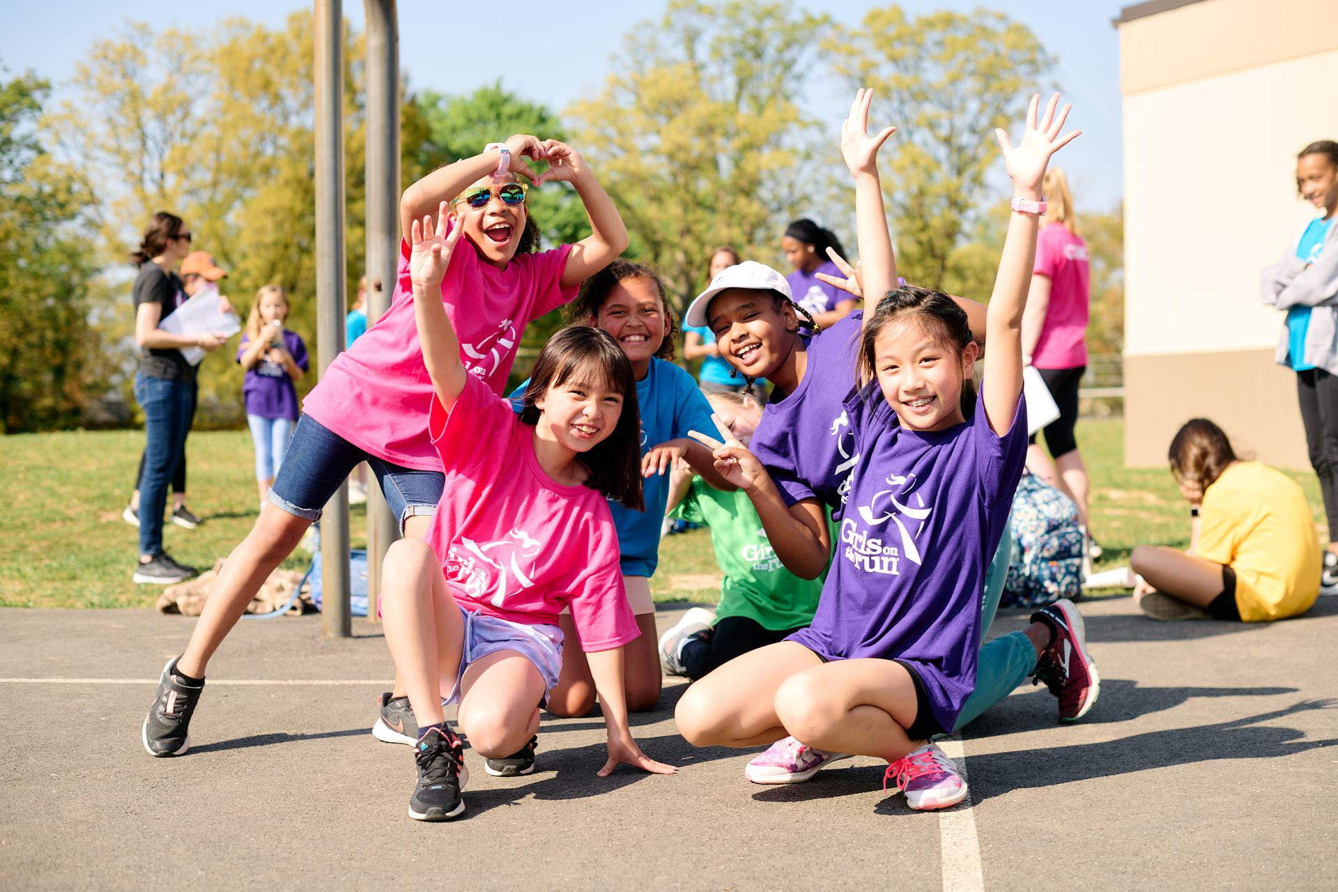 Group of kids smiling and posing for a photo.